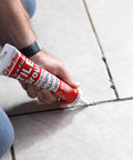 Applying Tile Grout Repair Gray Squeeze Tube 5.5 Ounce Pre Mixed Ready To Use Formula on ceramic tile grout lines