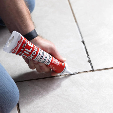 Applying Tile Grout Repair Gray Squeeze Tube 5.5 Ounce Pre Mixed Ready To Use Formula on ceramic tile grout lines