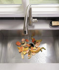 Half Horsepower Batch Feed Garbage Disposer For Home Kitchen with food scraps in stainless steel sink
