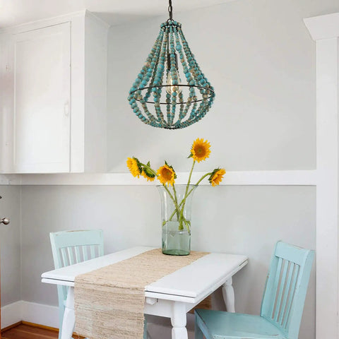 Wood Beaded Chandelier Light Fixture For Boho Farmhouse Vibe Pendant Ceiling Lamp in rustic grey-blue over a dining table.