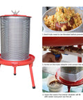 Water-Powered Fruit Wine Press For Home Cider And Natural Juice Making, Electricity-Free Hydraulic Press With 10.7 Gallon Capacity, Includes Filter Bag And Splash Guard, Awesome For Easy DIY Wine, Cider, And Fresh Juice. Red metal fruit press with mesh basket and hose adapter