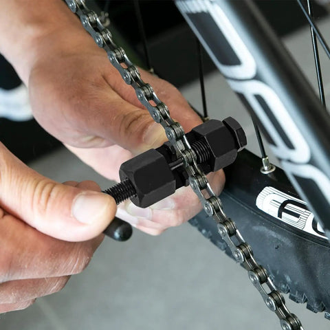 Using the Universal Bike Chain Breaker Tool For 1 To 13 Speed Chains With Spare Replaceable Pin on a bike chain