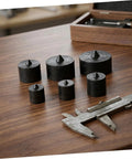 Outanaya 6pcs Heavy Duty Conical Shaft Protector Caps For Grip-O-Matic Pullers Machine Spindle Axle Guard Replacement Metal End Tips on wooden surface.