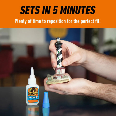 Hands repairing a lighthouse model using All Purpose Super Glue XL Clear Glue 25g Pack Of 2 For Fast Setting And Strong Bonds.