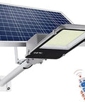 Heavy Duty Outdoor Solar Wall Light With Dusk To Dawn Sensor And Hella Bright Waterproof Led Security Flood Light Featuring A Wireless Remote Control For Driveway Use, showing solar panel and remote.