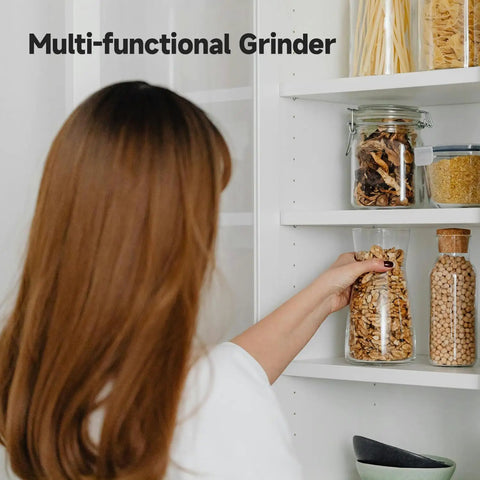 Woman reaching for jar of grains in kitchen pantry, showcasing storage alongside Beast 2000W Grain Grinder Mill With 550g Capacity Stainless Steel High Speed Pulverizer For Dry Wheat Oats Corn Pepper And Coffee Beans Home Kitchen Workhorse.