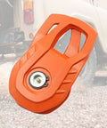 Snatch Block 55,000 LBS Heavy Duty Winch Pulley For Synthetic Rope Or Steel Cable, Off Road Recovery Tackle Block For Trucks ATVs UTVs And Tractors, Universal Orange on a vehicle tire