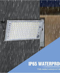 JUDYSSY Security Lights Led Floodlight Waterproof Spotlight Wall Light Ip65 Re mounted on wall, showcasing waterproof design in rain.