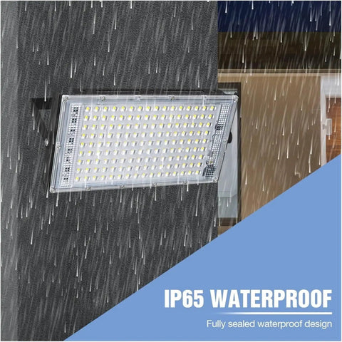 JUDYSSY Security Lights Led Floodlight Waterproof Spotlight Wall Light Ip65 Re mounted on wall, showcasing waterproof design in rain.