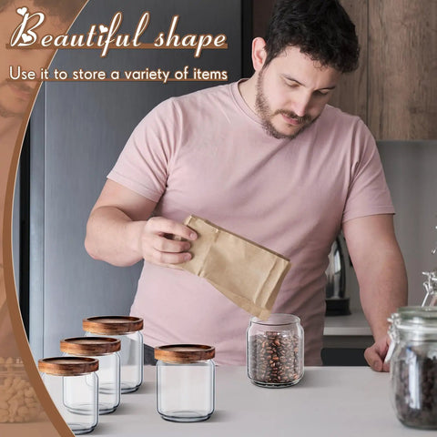 24 Pack Glass Canister Set With Tight Wood Lids For A No Sweat Pantry Setup, 17 Oz Food Jars being filled with coffee beans.