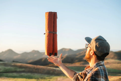 Man tossing HEX 2.0 No Frills Outdoor Chair For Camping And Stadium Seating With All Terrain Comfort Adjustable Straps
