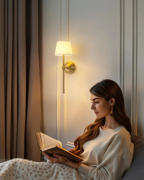 Legit Dope Gold Cordless Wall Sconces Set Of Two With Soft Beige Fabric and Warm LED lighting illuminating a woman reading.