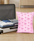 Large Waterproof Travel Laundry Bag Set For Wet Dry Gear, pink bow pattern next to packed suitcase, reusable drawstring pouch