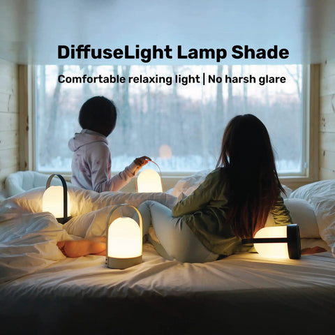 Two women sitting on a bed with Kin Portable Cordless Lantern Table Lamp With USB Rechargeable 4000mAh Battery, providing soft light.