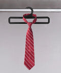Set Of 50 Black Plastic Hangers For Home And Retail Display, 7.7 Inch Long, shown holding a red tie