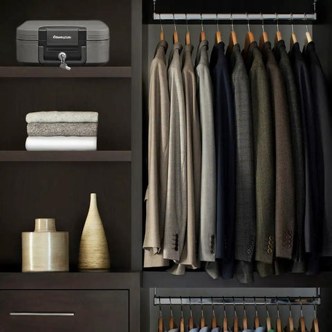 Fireproof And Waterproof Travel Safe Chest With Key Lock Black Lockbox in closet, beside folded clothes, UL Classified 1550F