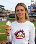 Woman wearing white shirt with ice cream drip baseball design at stadium, holding ice cream, showcasing DTF Transfers Ready To Press 30 Sheets Ice Cream Drip Baseball Iron On Patches For T Shirts Funny Sports Heat Transfer Decals For Clothes DIY Fabric Great For DIY Clothing.