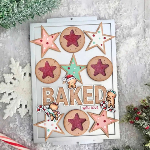Holiday-themed scrapbook card design with cookies, snowflakes, and the word 'Baked' in a festive setting.