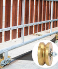 Built Like A Tank 4 Inch Sliding Gate Rollers Wheels 2 Pack, showing V Groove track wheels mounted on a wooden gate.