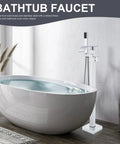 Freestanding Tub Filler With Handheld Shower Kit Floor Mounted Chrome Bath Faucet beside modern bathtub in a bright bathroom