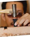Person using a hammer to install a 4 Pack Adjustable Barn Door Track Spacer, showing hands-on installation and strong bearing capacity.