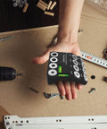 Drill Guide Jig With Two Torpedo Levels for 30, 45, and 90 degree holes in hand, nickel alloy steel, accessories scattered around