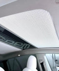 Fully Retractable Aluminum Sunroof Sunshade For Tesla Model Y installed over panoramic roof, blocking sunlight with a sleek design.