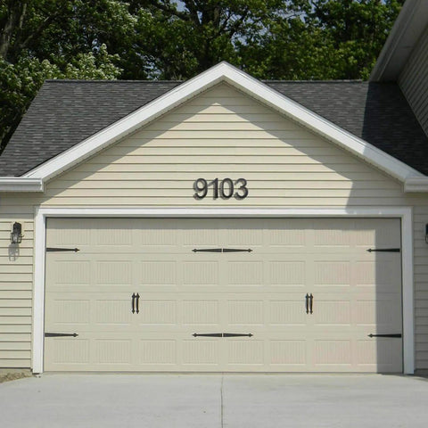 Garage with beige panel doors and black 9103 address sign, featuring 10 Inch Aluminum Floating House Number 2 in Black