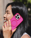 Woman holding Milan Snap Case For IPhone 16 Pro Max Pink Glitter MagSafe Compatible Case With 13 Foot Drop Protection outdoors