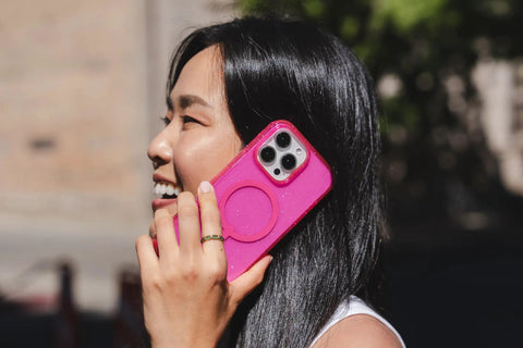 Woman holding Milan Snap Case For IPhone 16 Pro Max Pink Glitter MagSafe Compatible Case With 13 Foot Drop Protection outdoors