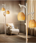 68 Inch Farmhouse Floor Lamp With Tree Trunk Faux Wood Column And White Washed Wicker Drum Shade in cozy living room corner