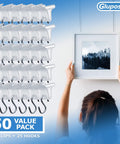 Clear Ceiling Grid Clips And S-Hook Hanging Kit, 50-Piece Drop Ceiling Decor Set shown with clips and hooks next to framed art.