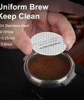 Person holding 51mm Espresso Puck Screen With Full Edge Holes, 0.8mm Thin 316 Stainless Steel, over portafilter basket.