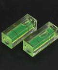 Small Spirit Level Square Bubble Level High Optical Transparency Material, two green bubble levels on black background.
