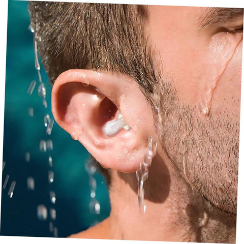 Close-up of reusable silicone ear plug in ear, keeping ear dry while water flows during swimming or showering.