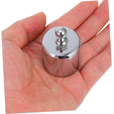 Person holding 200g weight for high precision calibration weights for digital scales and lab use, even weight distribution.
