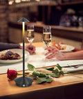 Cordless Table Lamp With 6000mAh Battery, Portable LED Desk Light on a dining table with a rose, modern triangle design