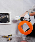Using 100 Foot Fiberglass Fish Tape 1/6 Inch Flexible Wire Puller For Electrical Conduit And Drywall to feed wires into a wall.
