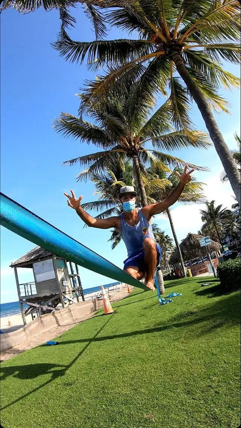 Person balancing on 60 Feet Slackline Kit With Tree Guards, Carry Bag, And Easy Setup For Family Fun, Kids And Adults, Durable Ratchet