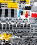 Close-up of Massive 844Pcs Pin Gears Axles Set for RC Cars and Tanks, showing gray, yellow, and red components arranged neatly.