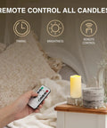 Hand holding remote for 2 Pack Outdoor Flameless LED Pillar Candles With Remote And Timer, Waterproof Battery Operated Flickering Candles.