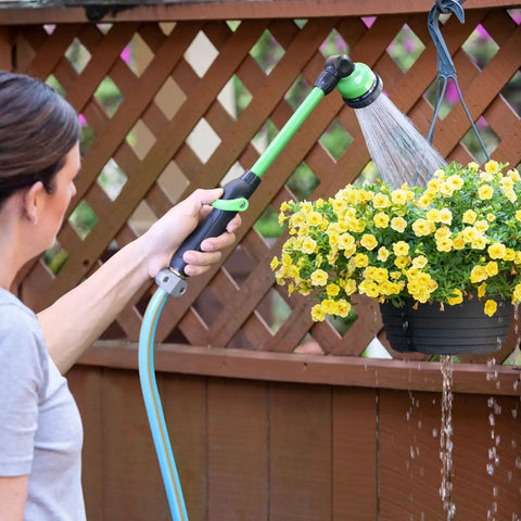 Woman using Lightweight 18 Inch Watering Wand With 9 Pattern Spray, Pivoting Head And Thumb Control on hanging basket