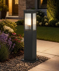 Slick Hardwired Outdoor Pathway Lights E26 Socket 23 Inch Tall landscaped lamp in garden, casting warm 3000K glow.