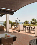 Square 7 By 7 Brown Sun Shade Sail Canopy UV Block For Backyard Porch seen over outdoor patio setup with seating and view.