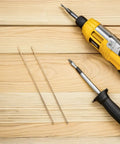 Two Brass Knife Pins For DIY Knife Handle Kits And Repairs, shown alongside a yellow electric drill and screwdriver on wooden surface.
