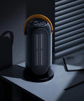 Portable Electric Heater For Indoor Use With Three Heat Modes And Thermostat, sleek black compact design on office desk