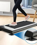 Person using treadmill on 4 Pack Double Sided Treadmill Floor Mat Pads Grippy Non Slip Anti Vibration Cushions Protect Hardwood Floors Safely