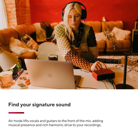 Musician using Scarlett Solo 4th Gen USB Audio Interface Bundle With Microphone And Guitar Preamps Studio Quality Sound 120dB Dynamic Range And 2 Year CPS Enhanced Protection Pack in home studio.