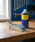 Beefy Sturdy Refrigerator Hinges With Thick Spring Loaded Design And Three Mounting Holes on wooden workbench with tools in background