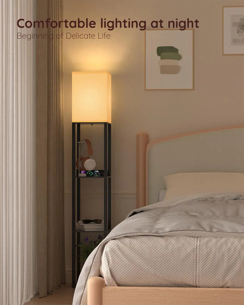 Shelf Floor Lamp With Solid Wood Shelves And USB Charging Ports in bedroom next to bed, matte black finish, glowing warm light